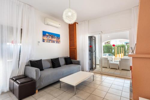 a living room with a couch and a table at Can Pep Ramon 2 in Sant Francesc de s'Estany