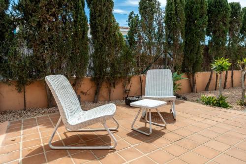 two chairs and a stool sitting on a patio at Can Pep Ramon 2 in Sant Francesc de s'Estany