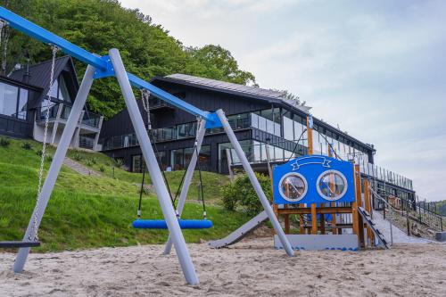 an empty playground in front of a building at NOI Resort SPA - woda i las in Tęgoborze
