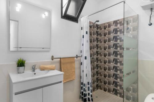 a bathroom with a sink and a shower at Cozy Paradise Apartment in Soo