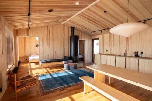 a living room with wooden paneling and a fireplace at Kalamaja Kilpisjärvi in Kilpisjärvi