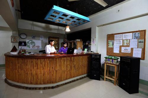 two people standing at a bar in a restaurant at Jayanta Hotel in Chittagong
