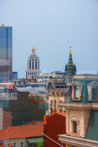 a city skyline with buildings and a christmas tree at Bel Mare Boutique Hotel in Batumi