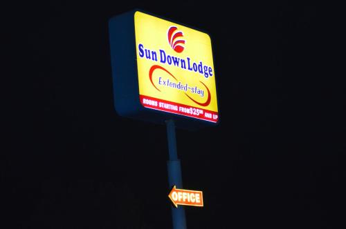 a sign for a sun dominion envelope on a pole at Sun Down Lodge in Locust Grove