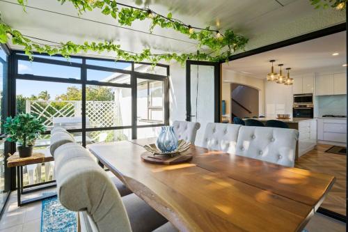 a dining room with a wooden table and chairs at Not usually available – Lucky U! in Auckland