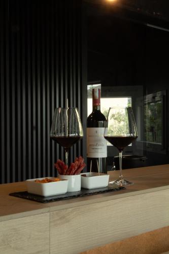 a bottle of wine and a glass on a counter at Spera Luxury in Monreale