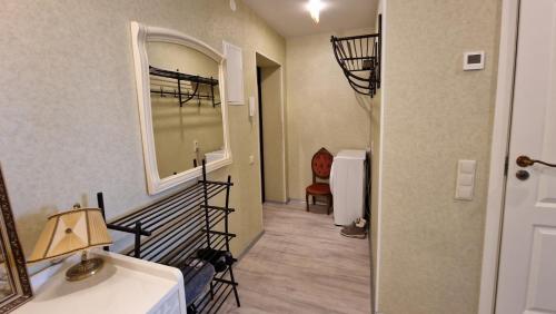a hallway with a sink and a mirror in a room at Amber Beach Apartment in Narva-Jõesuu