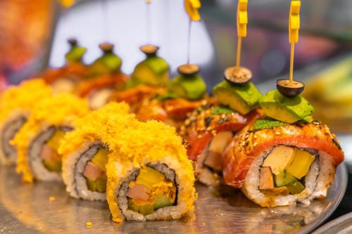 a group of sushi on a plate with tooth picks at Shangri-La Wuhan,Close to The Mixc with three subway lines in Wuhan