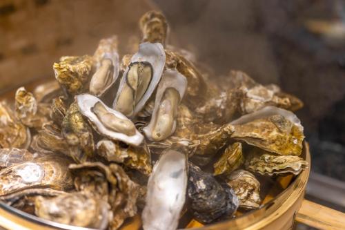 a bowl of oysters on a table at Shangri-La Wuhan,Close to The Mixc with three subway lines in Wuhan