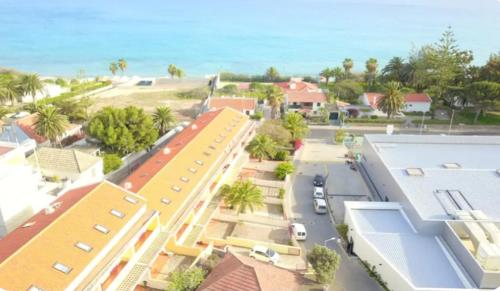a model of a city with buildings and the ocean at Angela Beach Place in Vila Baleira