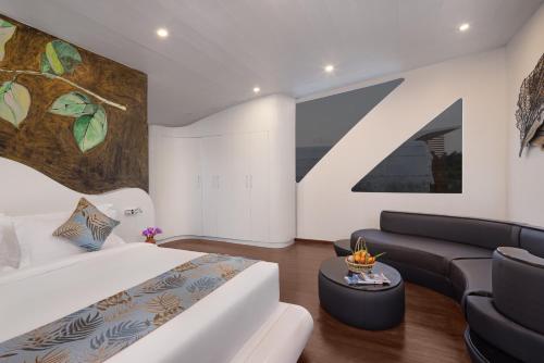 a bedroom with a king sized bed and a couch at Bolagala Agro Floating Resort in Negombo