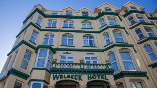 a large building with a wellesley hotel sign on it at Welbeck Hotel & Apartments IOM in Douglas