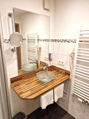 a bathroom with two sinks and a mirror at Landgasthof Rebstock in Ottenhöfen