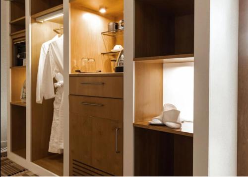 a bathroom with a walk in closet with wooden cabinets at Islington Hobart - Wellington Suite - Australia in Hobart