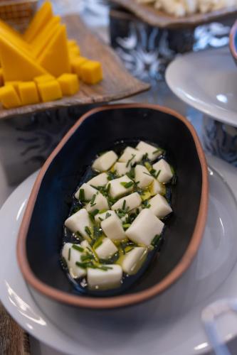 a bowl of food with cheese and herbs on a table at Belenli Resort Hotel in Belek