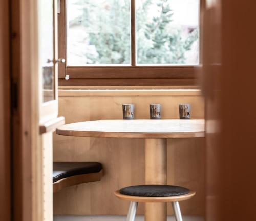 a bathroom with a sink and a window and a stool at Apartment Misalt in Castelrotto