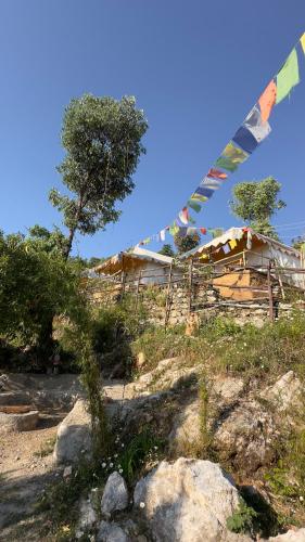a house on a hill with flags on it at Ananta Prana in Mussoorie
