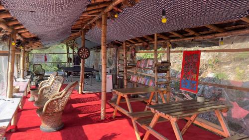 a group of chairs and tables in a room at Ananta Prana in Mussoorie