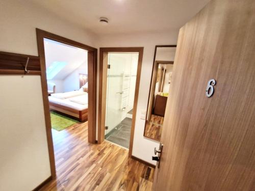 an open door to a room with a bedroom at Landgasthof Rebstock in Ottenhöfen