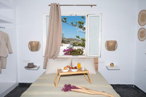 Zimmer mit einem Tisch und einem Fenster in der Unterkunft Boutique di Vito in Mykonos Stadt