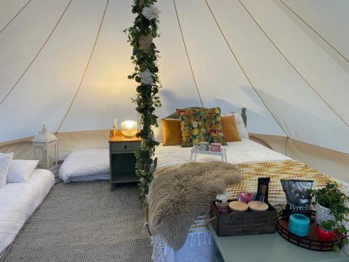 um quarto com uma cama numa tenda em Top pen y parc farm bell tent em Halkyn