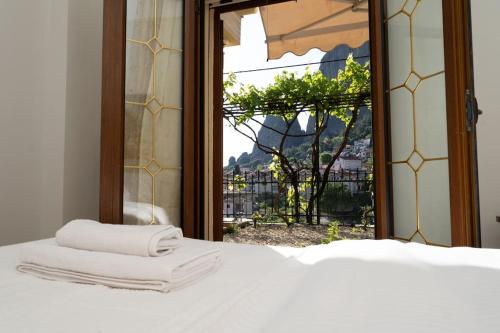 a bedroom with a bed with three towels on it at Romance Dream Meteora 2 in Kalabaka