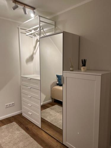a dressing room with a mirror and a dresser at Ferienwohnung Kempkens -Hochwertig & modern in Straelen