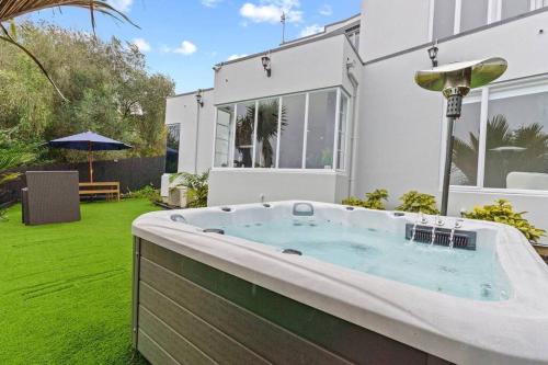 a hot tub in the backyard of a house at Entire home in Central Auckland in Auckland