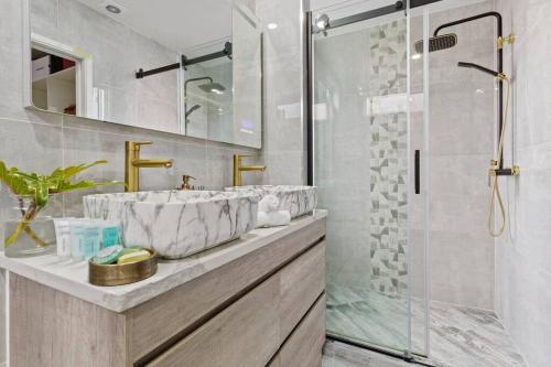 a bathroom with a sink and a shower at Entire home in Central Auckland in Auckland