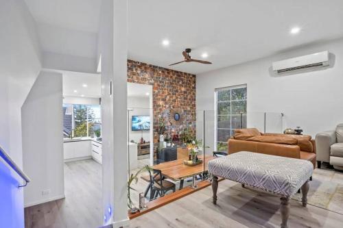 a living room with a couch and a table at Entire home in Central Auckland in Auckland