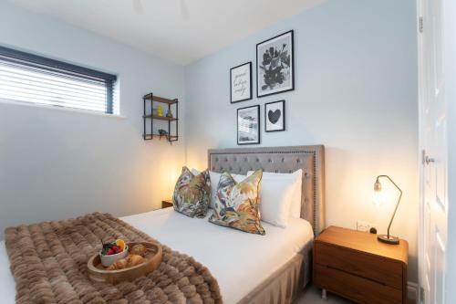 a bedroom with a bed with a bowl on it at Elliot Oliver - Stylish 2 Bedroom Apartment With Parking In The Docks in Gloucester