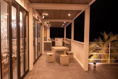 a balcony with benches and tables on a building at 海都-kaito- TOKYOBAY in Futtsu