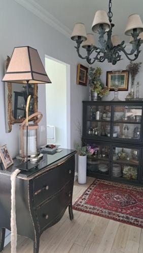 a room with a dresser with a lamp on it at Appartement de standing a Bailly 78870 in Bailly