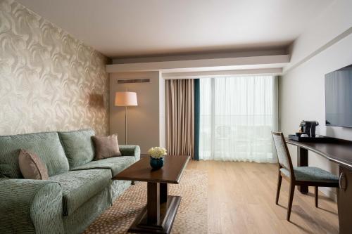a living room with a couch and a table at Ana Hotels Europa Eforie Nord in Eforie Nord
