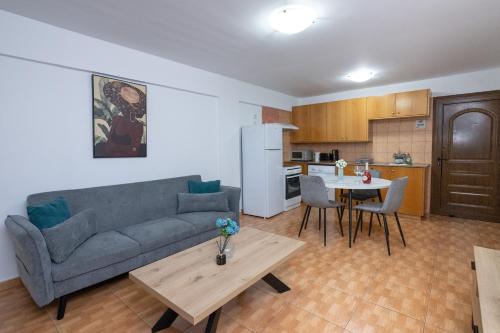 a living room with a couch and a table at Napa Centrale Suites in Ayia Napa