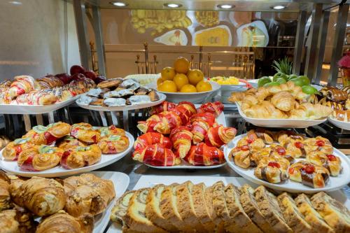 a buffet filled with different types of pastries and pies at Maien Taiba in Al Madinah