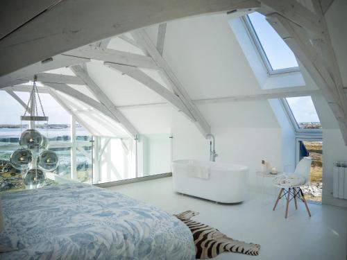 1 dormitorio con cama y ventana grande en Doleen Quay House, en Ballyconneely