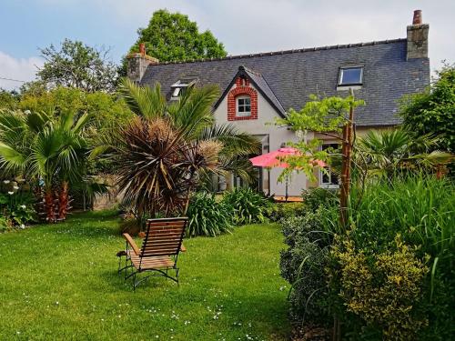 a house with a chair in the yard at 690-Villa Ty Kastell in Audierne