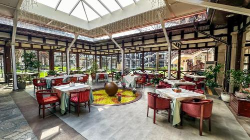 a restaurant with tables and chairs in a building at Spa Hotel Ismena in Devin