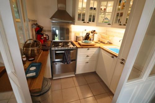 a small kitchen with a stove and a sink at 690-Villa Ty Kastell in Audierne