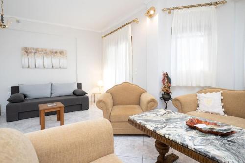 a living room with couches and a table at Romance Dream Meteora 1 in Kalabaka