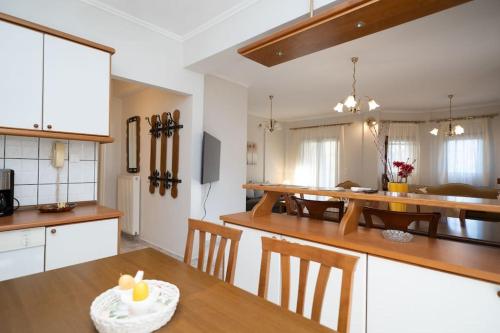 a kitchen and living room with a table and a dining room at Romance Dream Meteora 1 in Kalabaka
