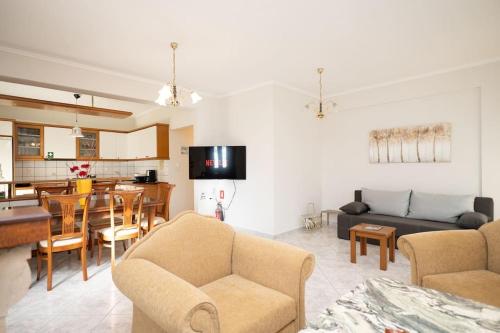 a living room with a couch and a dining room at Romance Dream Meteora 1 in Kalabaka