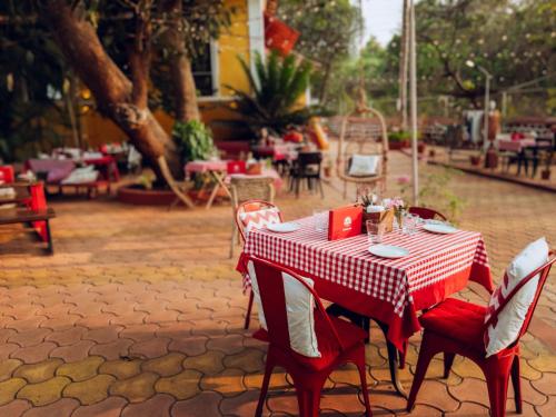 a table with a red and white checkered table cloth at Casa Do Leão A 150 year Old Portuguese Home in Nerul