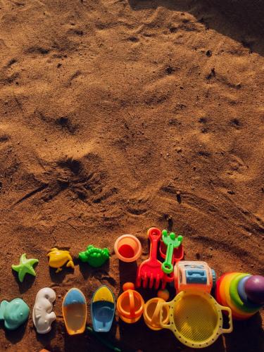 a group of toys on the sand on the beach at Casa Do Leão A 150 year Old Portuguese Home in Nerul