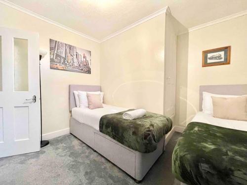 um quarto com duas camas e uma porta para um quarto em The Lancaster - relax and enjoy home near City Center with parking em Canterbury
