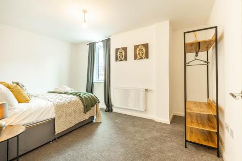 a bedroom with a bed and a mirror at Comfy 2-Bed Flat in Dartford, Kent. in Kent