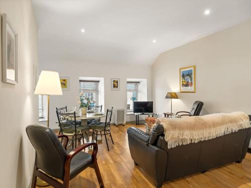 a living room with a couch and a table at Town centre apartment, Clifden in Clifden