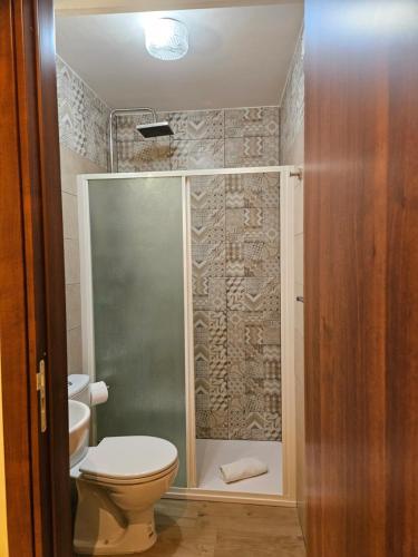 a bathroom with a toilet and a glass shower at Casa Nicole - Letojanni Taormina in Letojanni