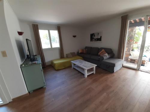 un salon avec un canapé et une table dans l'établissement Maison indépendante en pleine Nature, à Roquebrune-sur Argens